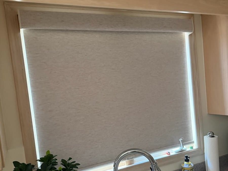 Custom roller shade lowered over a kitchen window in Kinnelon, NJ